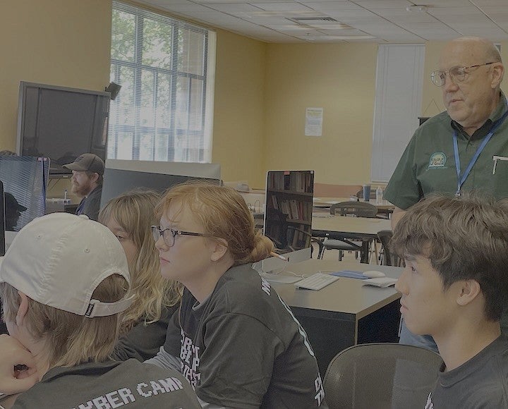 High school studens working on cybersecurity project on computer