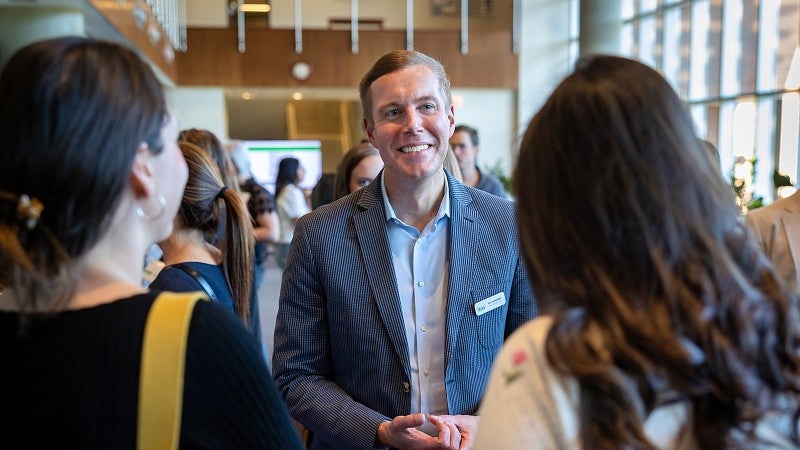 smiling man talking to people