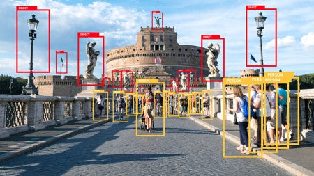 A bridge with people and red and yellow boxes over parts of the photo