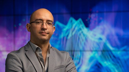 man standing in front of abstract data visualization