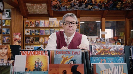 professor Ben Saunders browsing comic books in a store