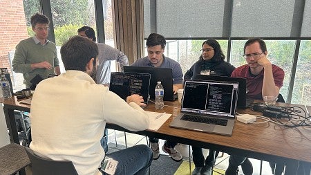People at a table working at computers