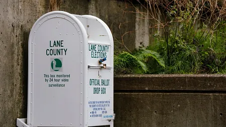 Photo of a white and green Lane County elections ballot box