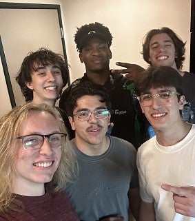 group of young men looking at the camera as they take a selfie