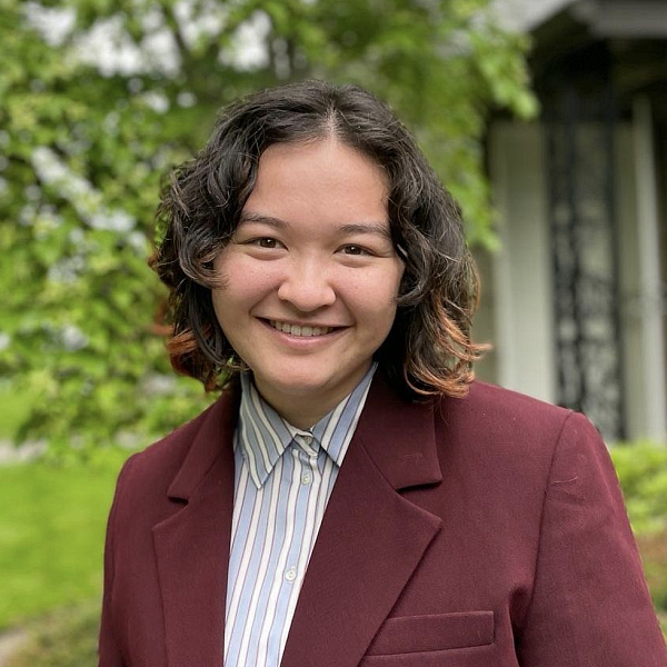 student posing for portrait outside