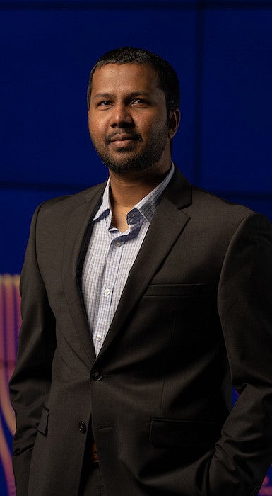 man posing in front of digital graphic background