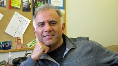 computer scientist Reza Rejaie poses sitting in an office