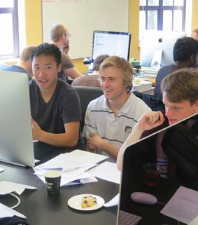 3 students looking at computer at 2015 Luks Programming Contest